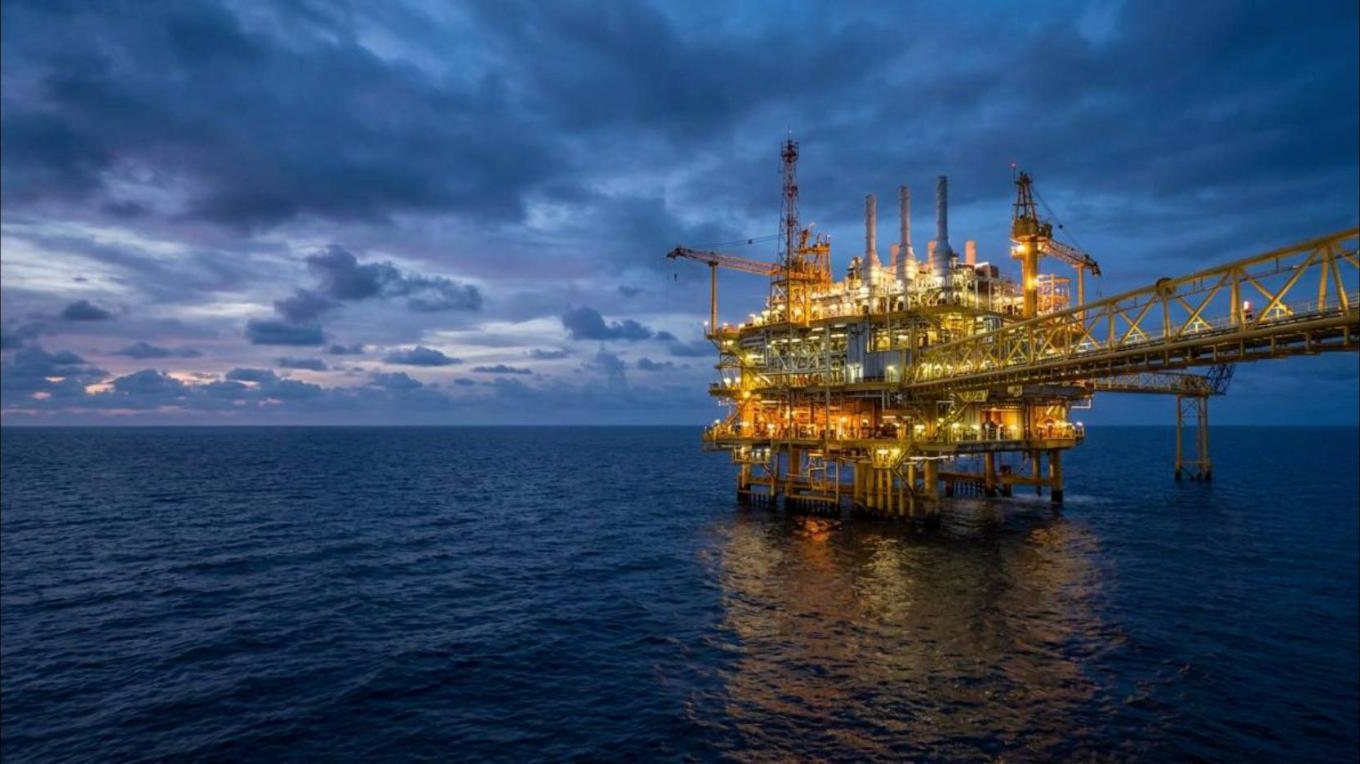 Offshore oil and gas platform at blue hour